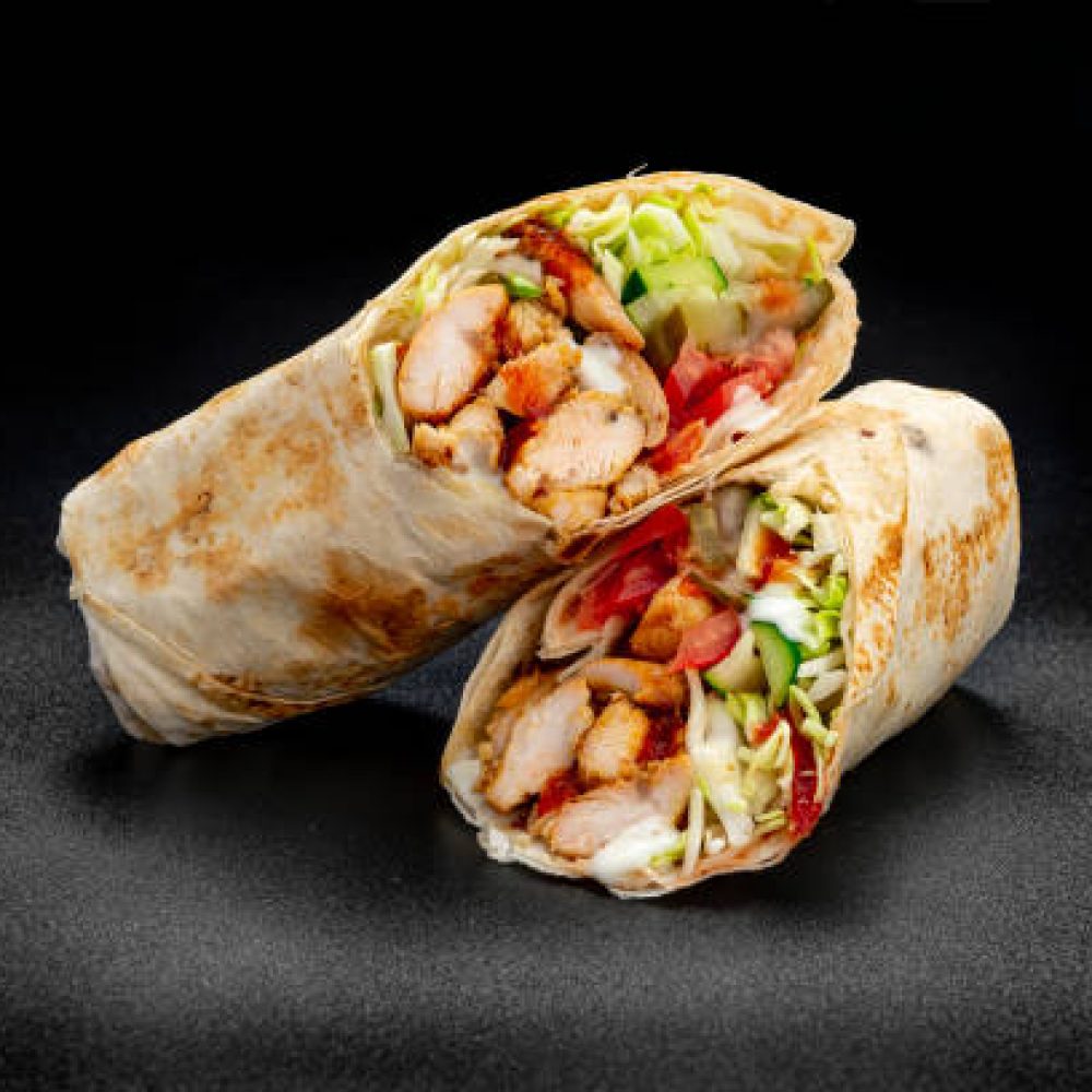 Beef shawarma on a dark background. Shawarma with beef in pita bread. Photo for the menu
